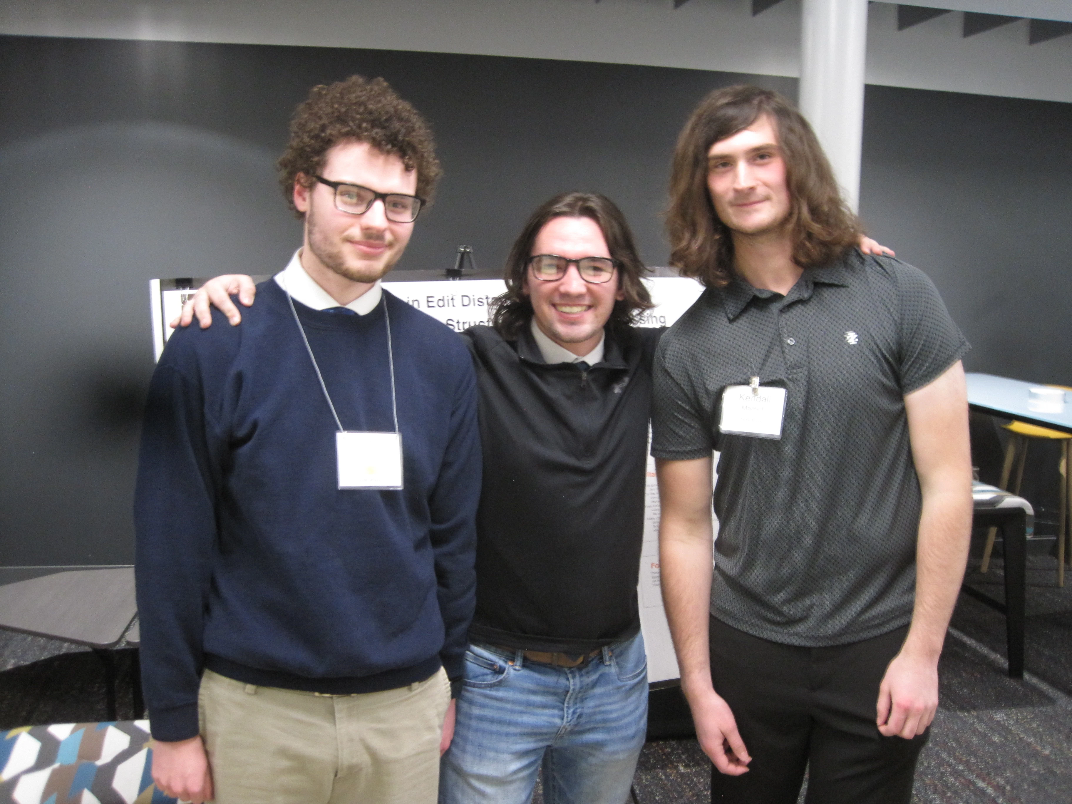 group photo of gavin, kendall, and me infront of our CEMS poster